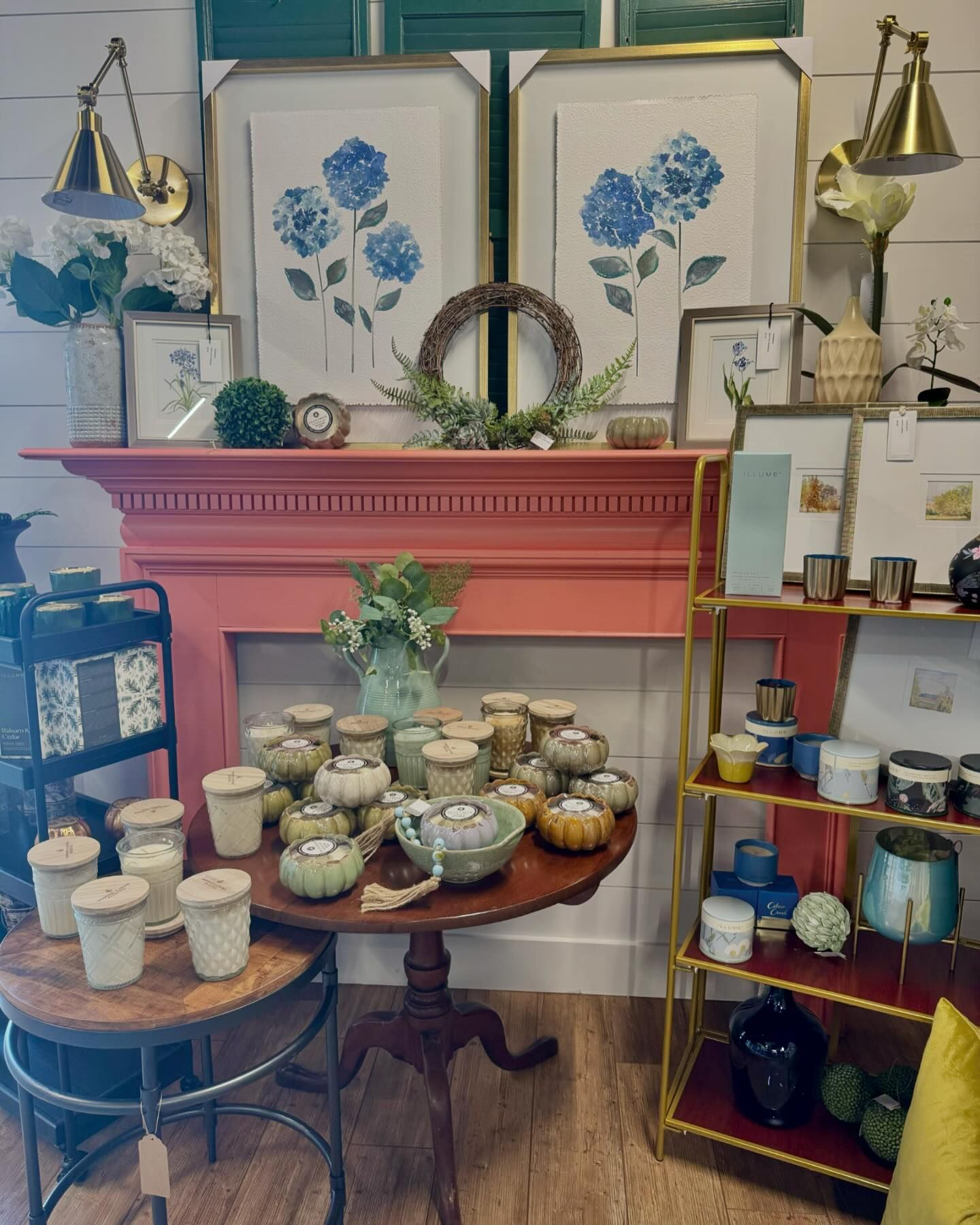 Candles on display on a table, rack and mantel.